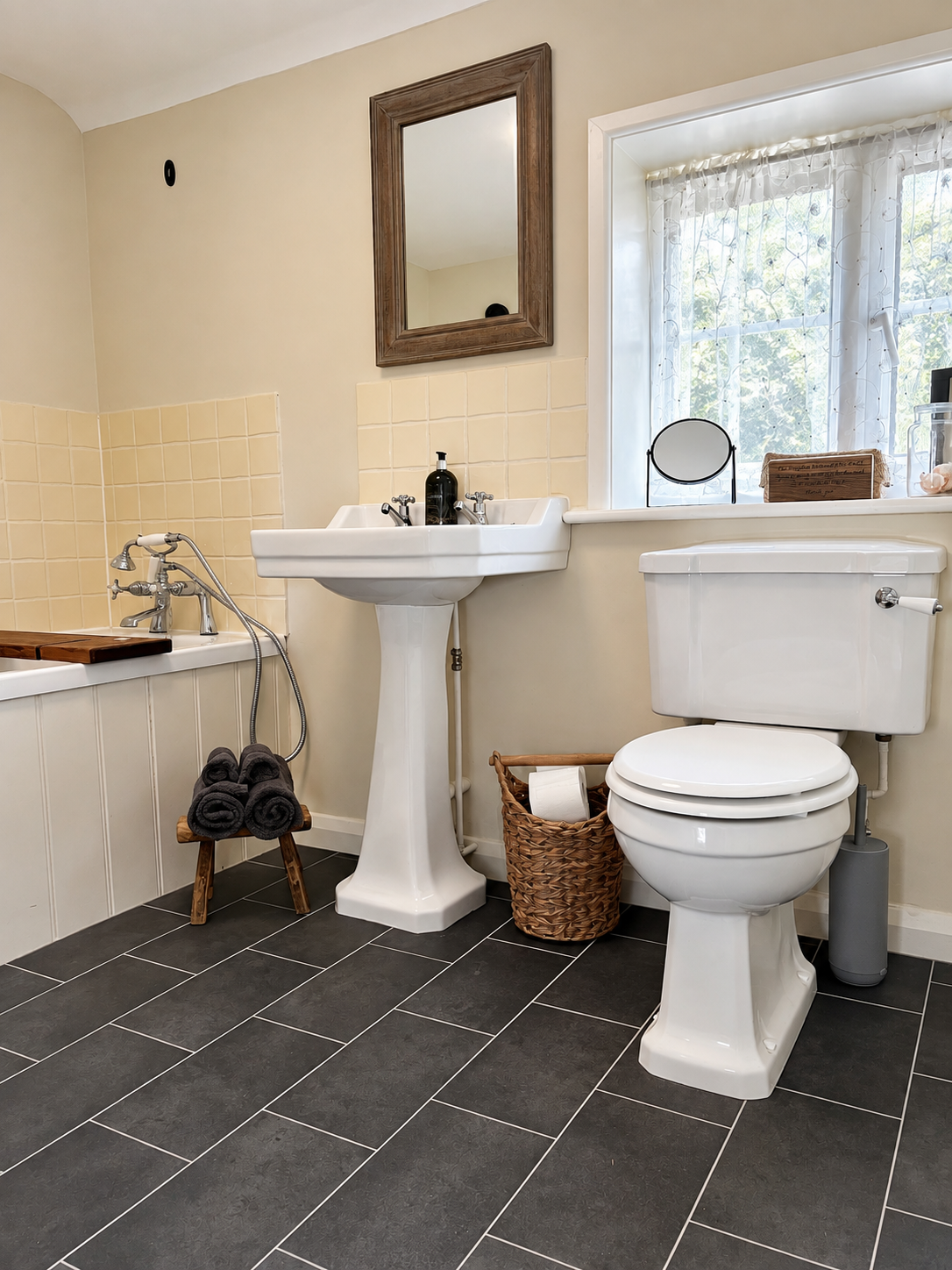 Bathroom with a bath, sink and toilet at The Piggery